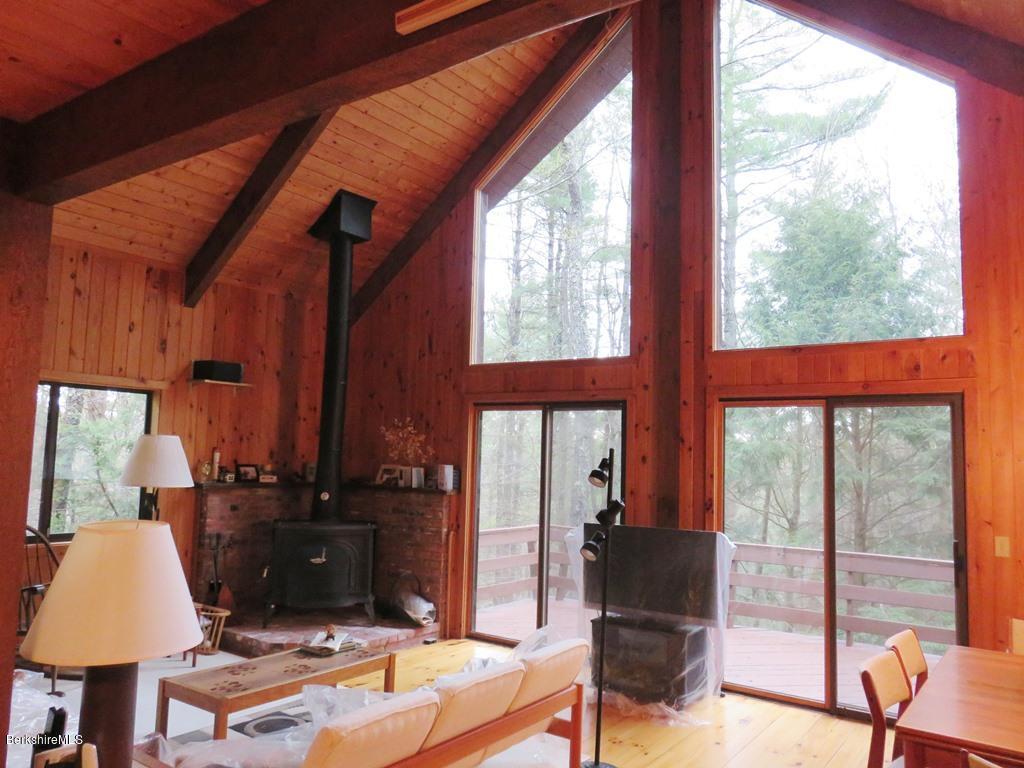 7 Sunset Court Otis, MA 01253 - Photo 2 of 21 a living room with table and a flat screen tv
