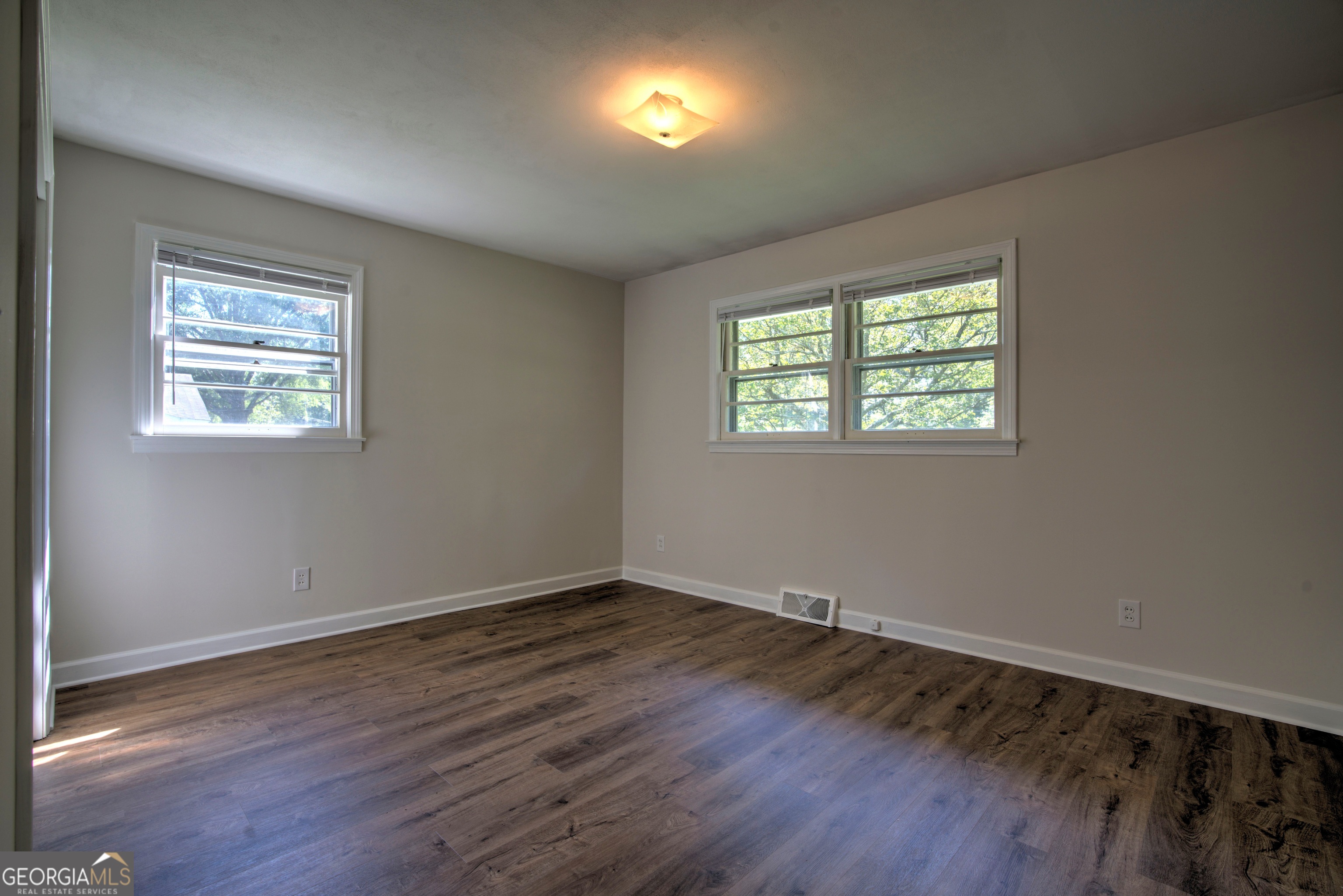 25 Ridge Drive Southwest Rome, GA 30165 - Photo 14 of 37 a view of an empty room with wooden floor and a window