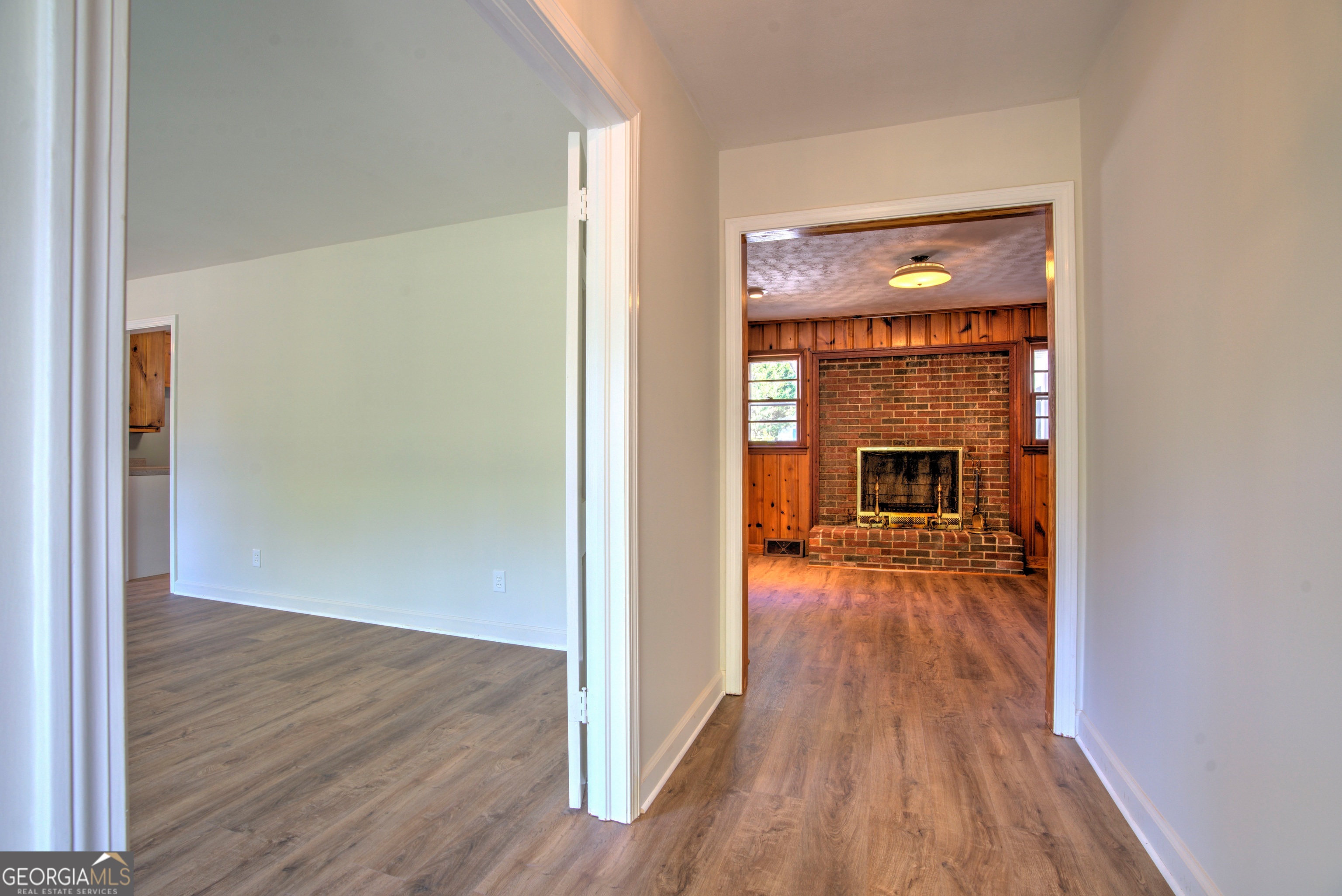 25 Ridge Drive Southwest Rome, GA 30165 - Photo 3 of 37 a view of empty room with wooden floor and fireplace