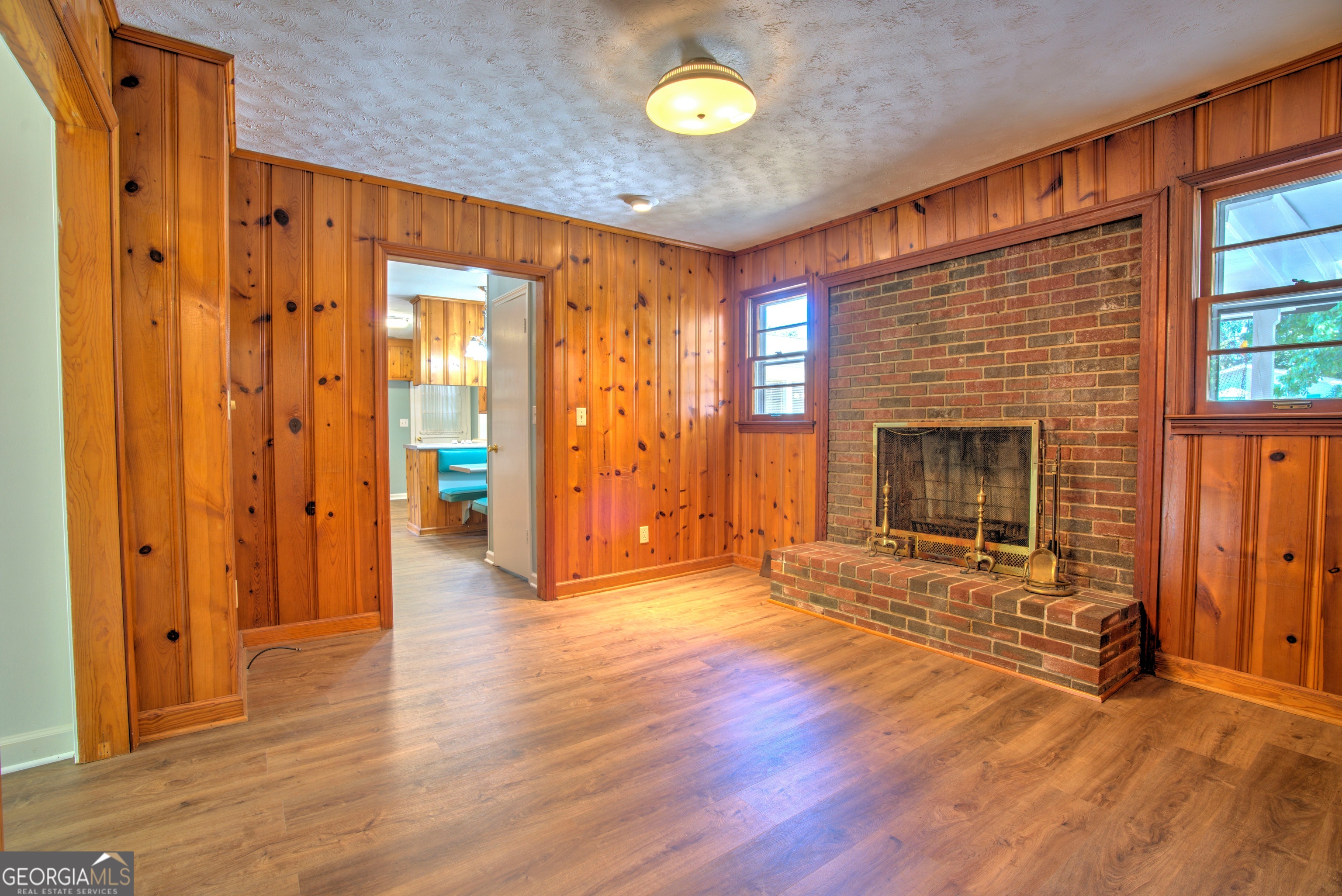 25 Ridge Drive Southwest Rome, GA 30165 - Photo 4 of 37 a view of an empty room with wooden floor and a fireplace
