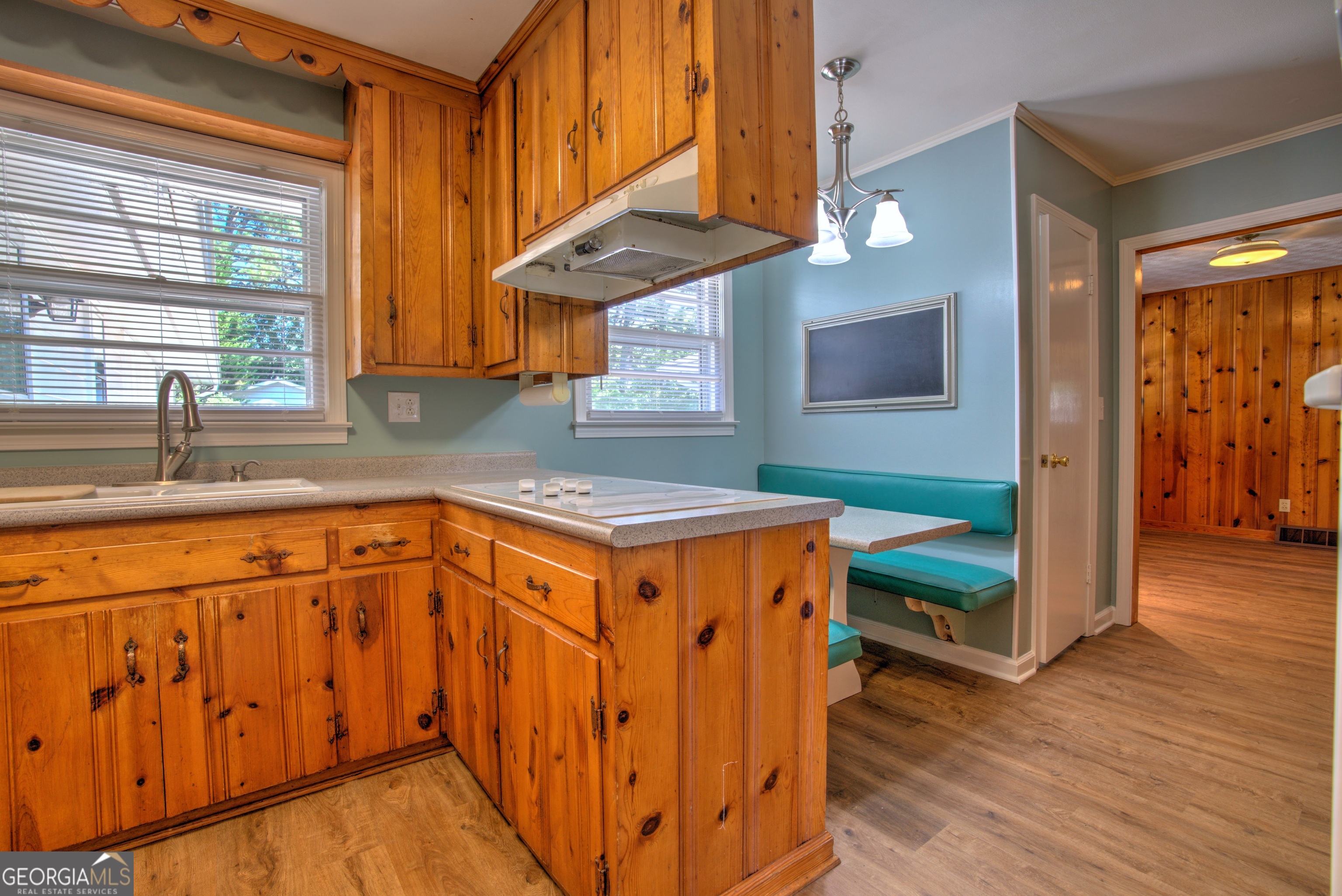 25 Ridge Drive Southwest Rome, GA 30165 - Photo 8 of 37 a kitchen with stainless steel appliances granite countertop a sink a stove a dining table and chairs with wooden floor