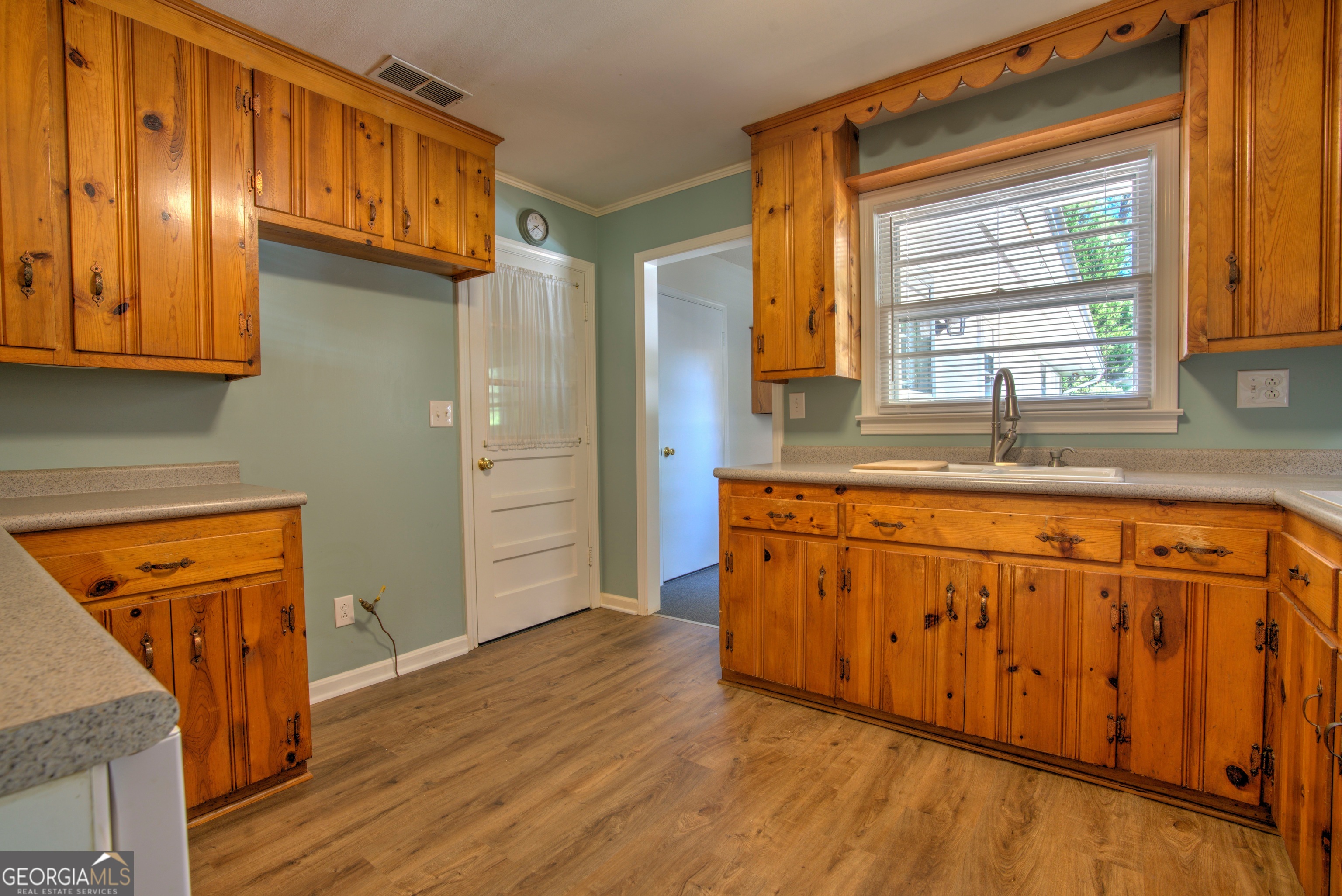 25 Ridge Drive Southwest Rome, GA 30165 - Photo 9 of 37 a kitchen with granite countertop wooden cabinets a sink and a window