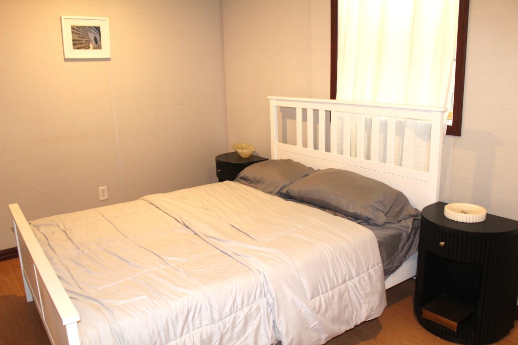 33 Bartlett Road Nantucket, MA 02554 - Photo 22 of 29 a bedroom with a bed and a window