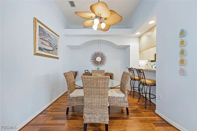 a kitchen with stainless steel appliances a refrigerator sink and white cabinets