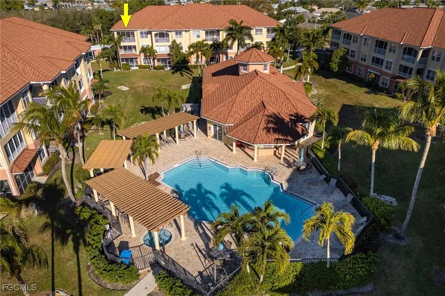 an aerial view of a house with yard swimming pool and outdoor seating