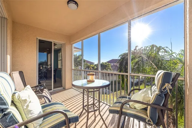 a living room with furniture fireplace and a large window