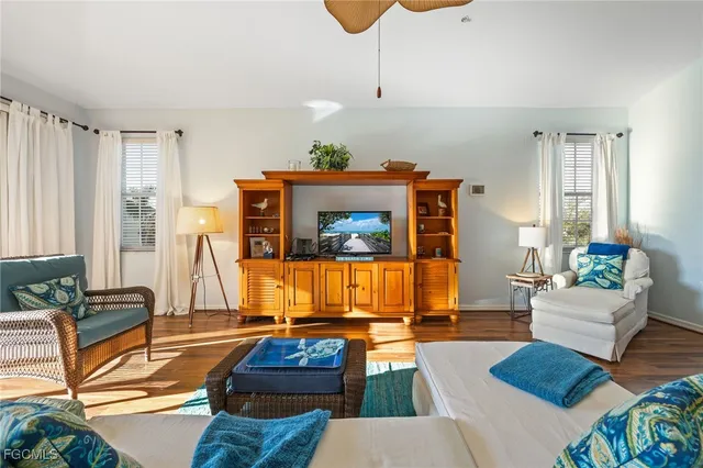 a view of a bedroom with furniture window and wooden floor