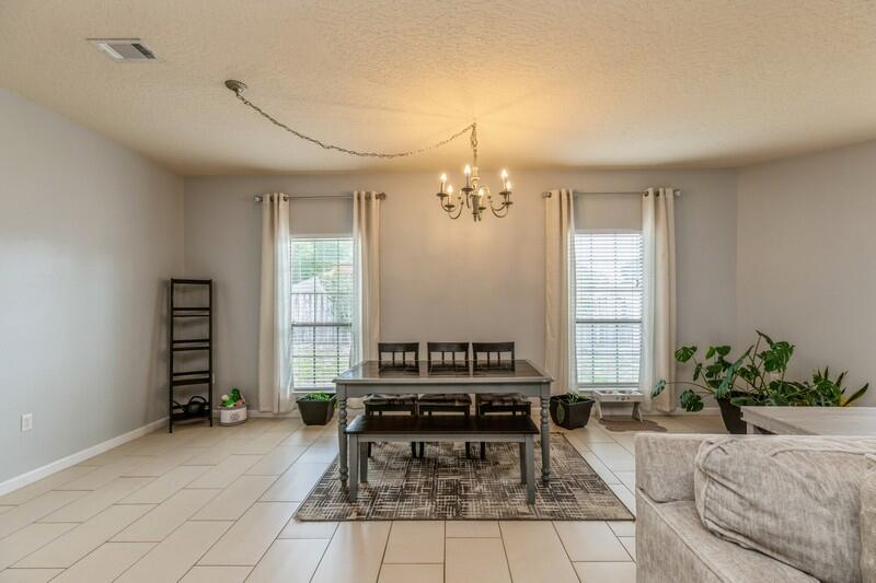 4596 Hermosa Road Crestview, FL 32539 - Photo 14 of 35 a living room with furniture and a chandelier