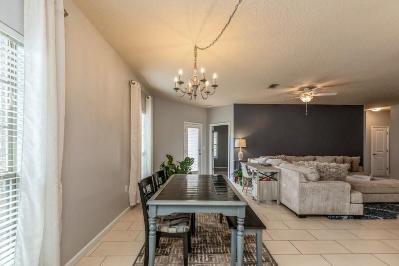 4596 Hermosa Road Crestview, FL 32539 - Photo 15 of 35 a living room with furniture and a chandelier