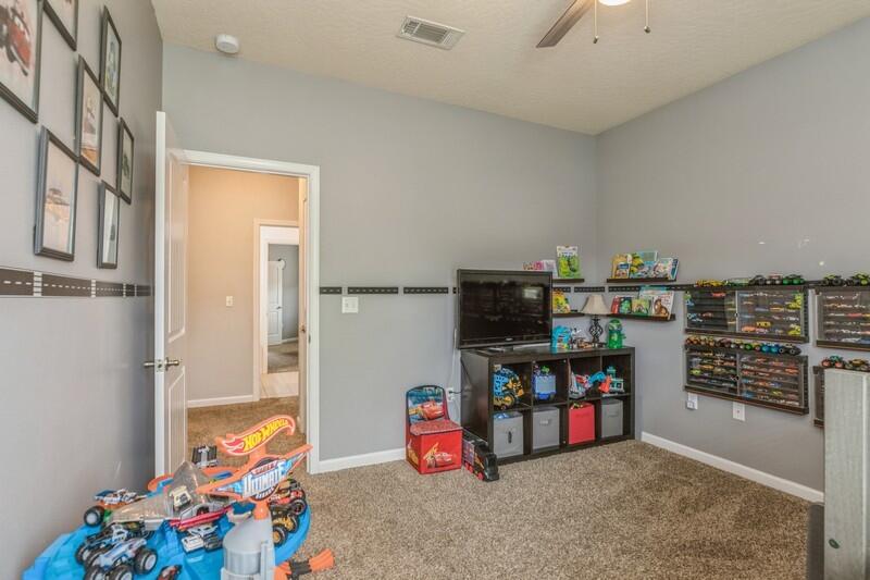 4596 Hermosa Road Crestview, FL 32539 - Photo 26 of 35 a room with lots of white furniture and wooden floor