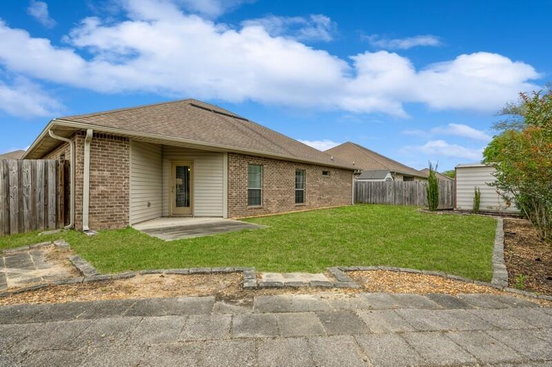 4596 Hermosa Road Crestview, FL 32539 - Photo 32 of 35 a view of a yard in front of a house with a large tree