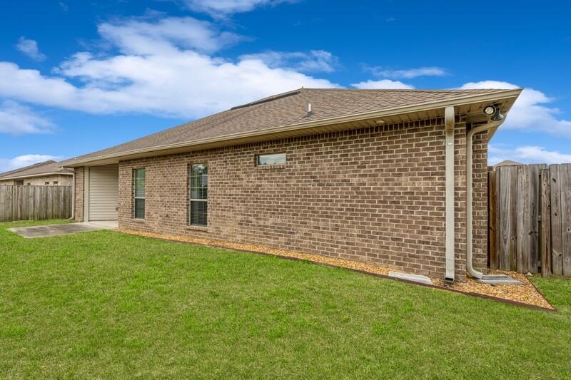 4596 Hermosa Road Crestview, FL 32539 - Photo 34 of 35 a front view of a house with a garden