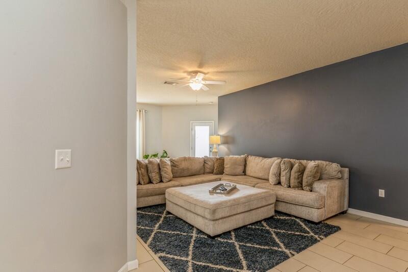 4596 Hermosa Road Crestview, FL 32539 - Photo 5 of 35 a living room with furniture a chandelier and a window
