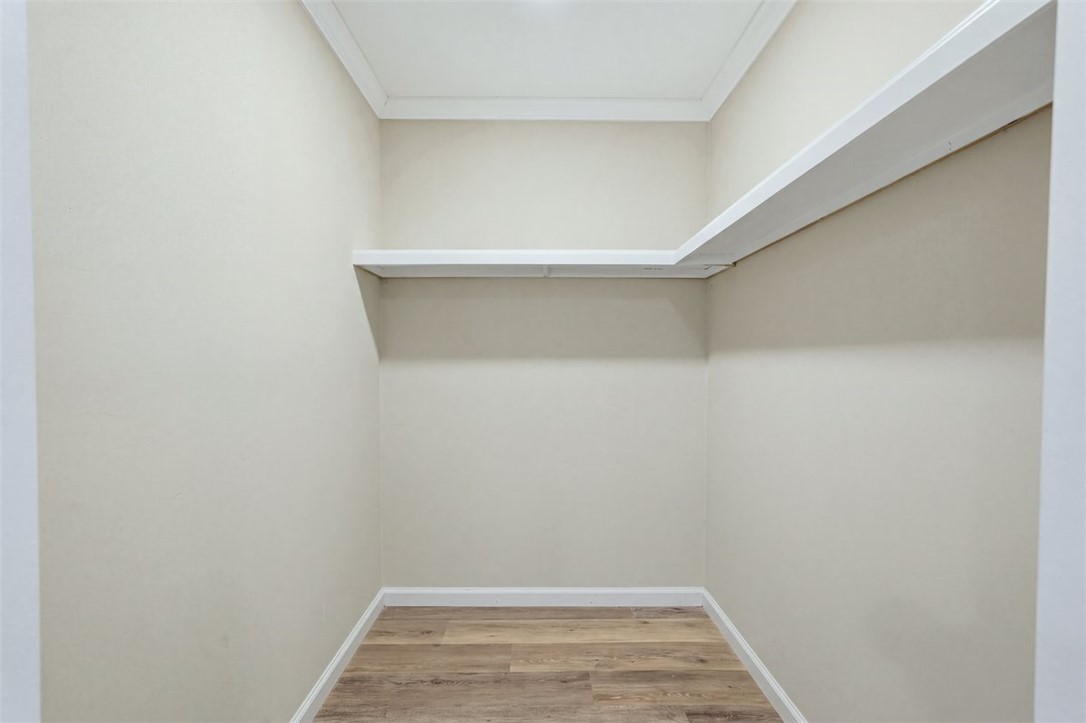 418 Old River Road Pelzer, SC 29669 - Photo 24 of 32 Functional shelving and wood floors define this practical walk-in closet space.