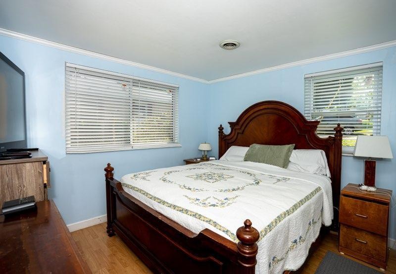 123 Manchester Road Oak Ridge, TN 37830 - Photo 15 of 26 a bed sitting in a bedroom next to a window with wooden floor