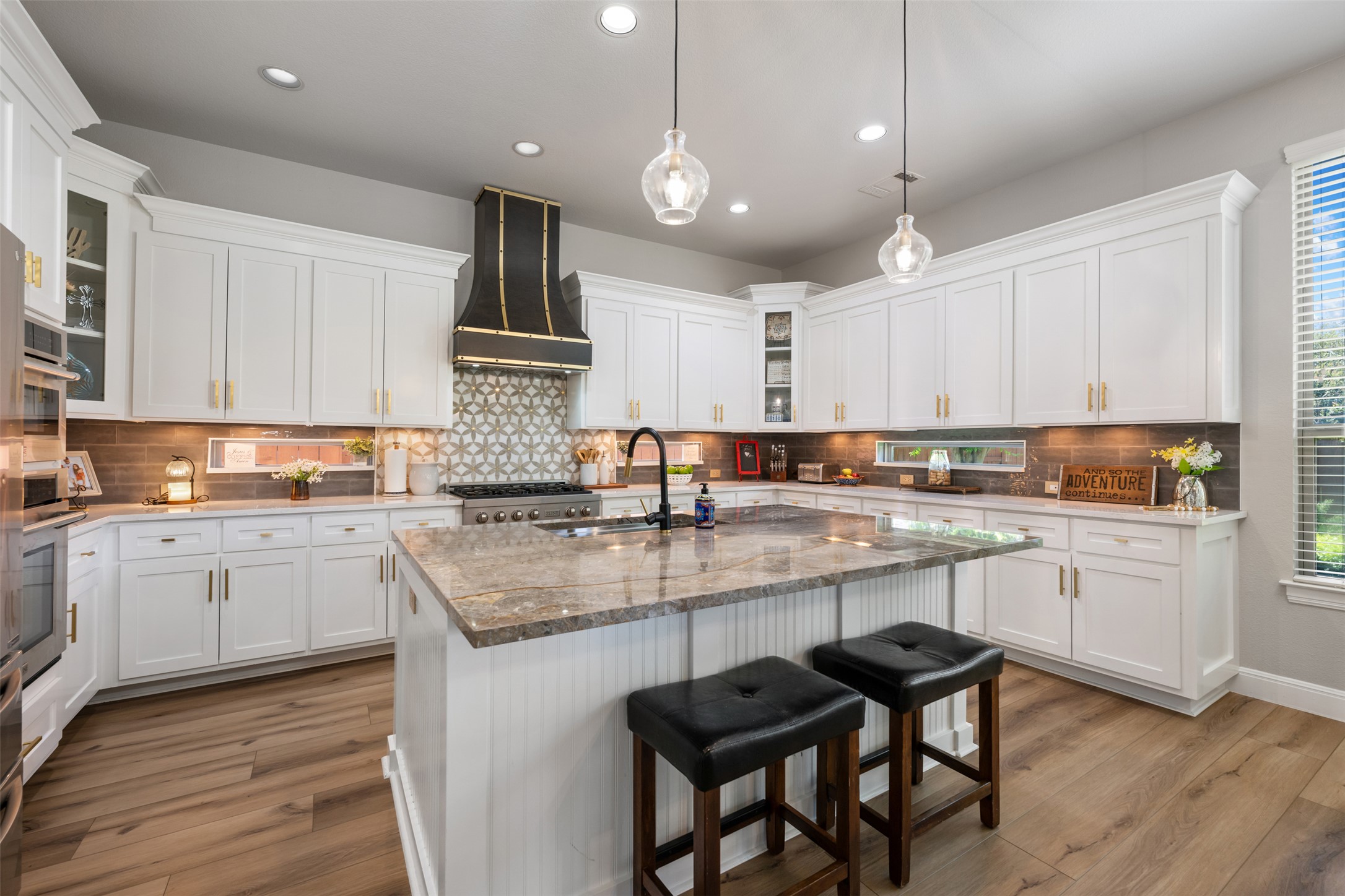 3021 Wedgescale Pass Leander, TX 78641 - Photo 9 of 40 a kitchen with stainless steel appliances granite countertop a stove top oven a sink dishwasher and white cabinets with wooden floor