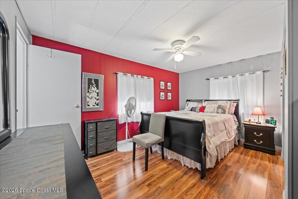 1740 Seagrape Street Northeast Palm Bay, FL 32905 - Photo 10 of 33 a bedroom with a bed and a table in it