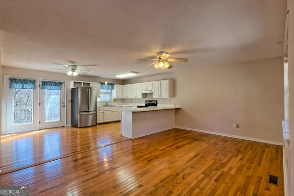 a view of kitchen with cabinets and wooden floor