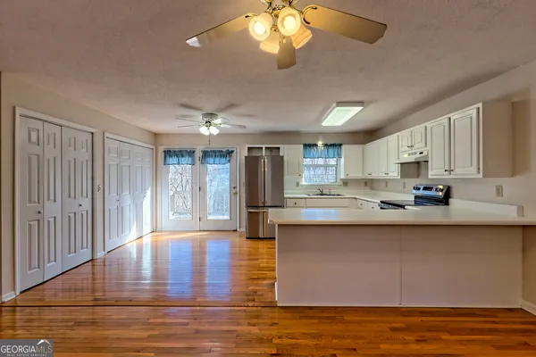 a view of an empty room with window and cabinet
