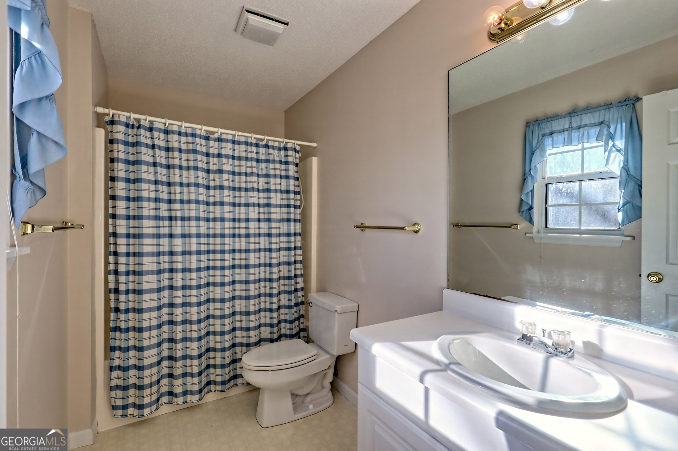 170 White Street Dillard, GA 30537 - Photo 24 of 58 a bathroom with a sink a toilet and shower curtain