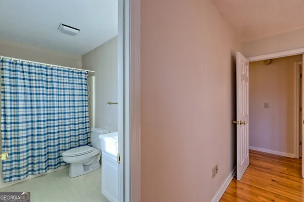 a view of empty room with wooden floor