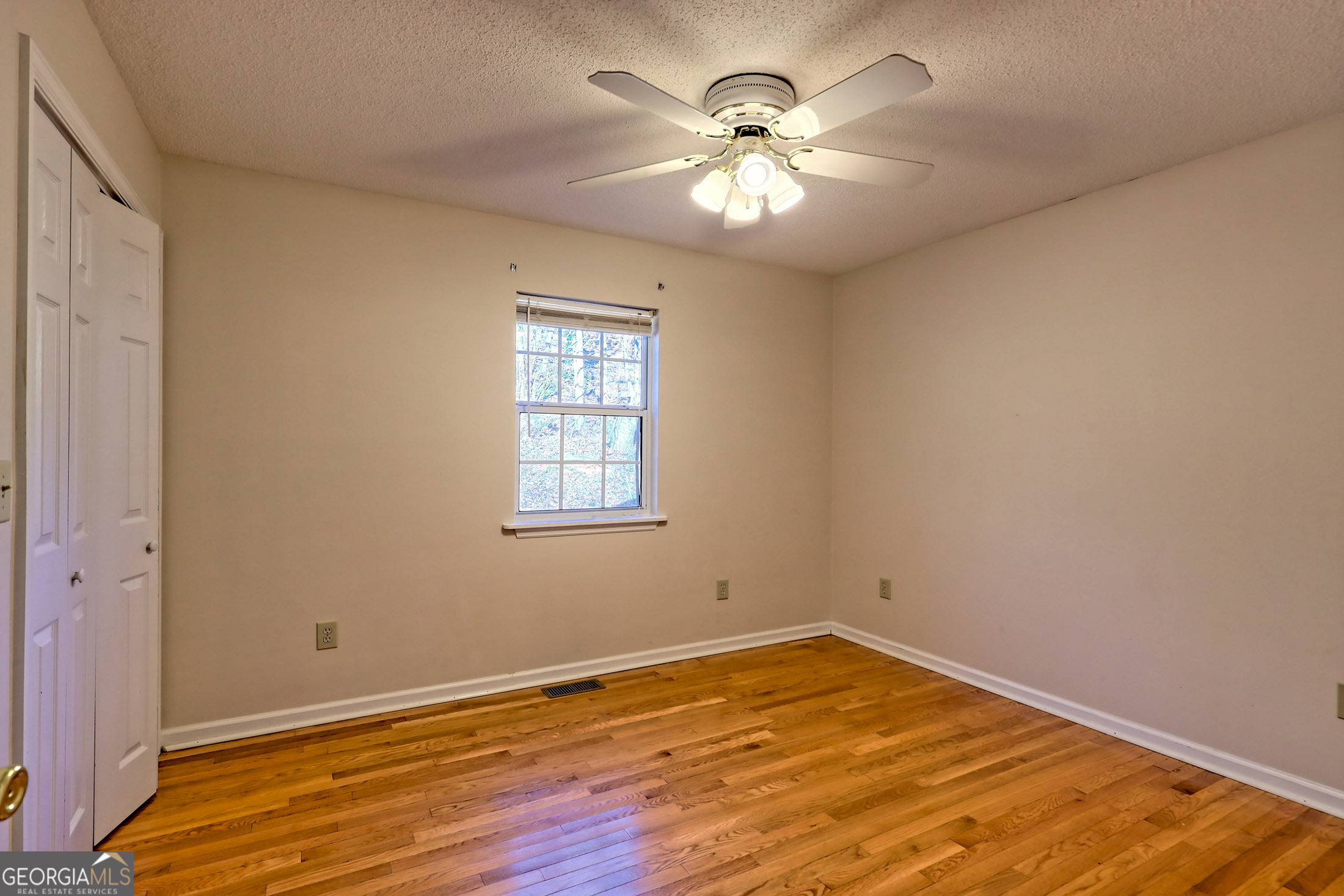 170 White Street Dillard, GA 30537 - Photo 29 of 58 wooden floor in an empty room with a window