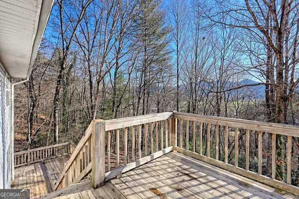 a view of roof with wooden floor and fence