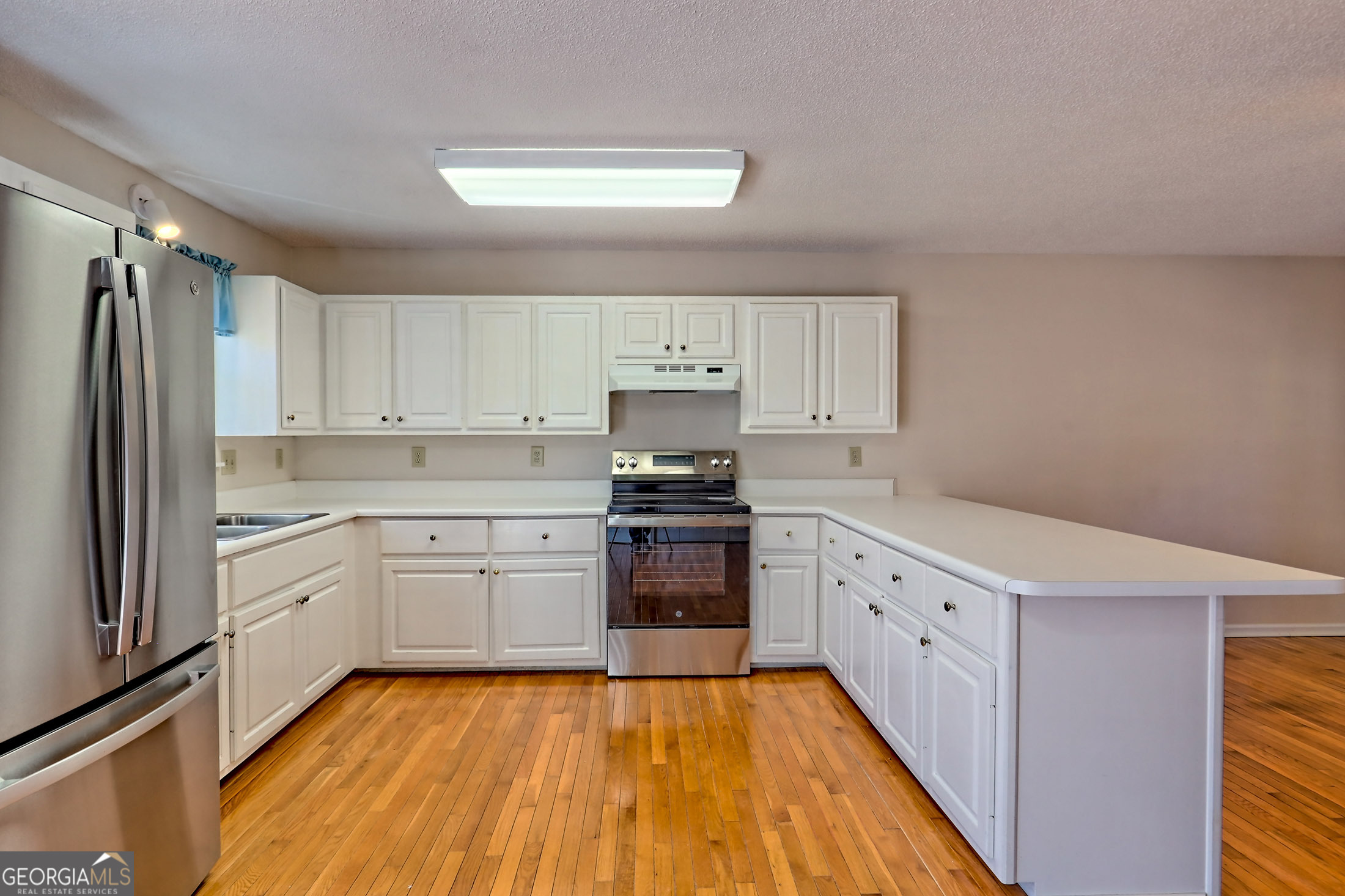 170 White Street Dillard, GA 30537 - Photo 5 of 58 a kitchen with granite countertop white cabinets and stainless steel appliances
