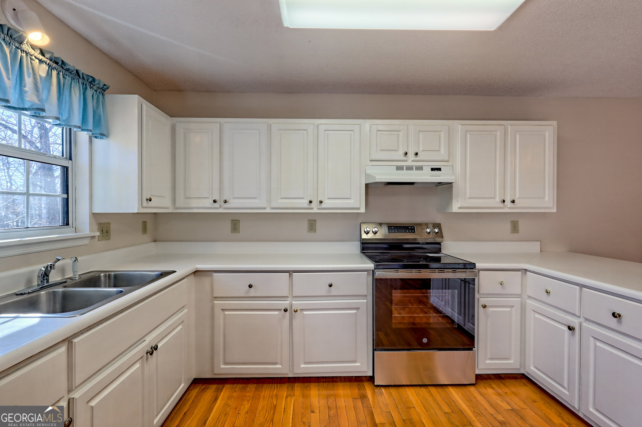 170 White Street Dillard, GA 30537 - Photo 6 of 58 a kitchen with white cabinets stainless steel appliances and sink