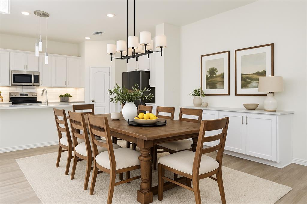 1336 Morning View Road Georgetown, TX 78628 - Photo 12 of 40 A grand chandelier illuminates this open-concept dining area, seamlessly flowing into a well-appointed kitchen.