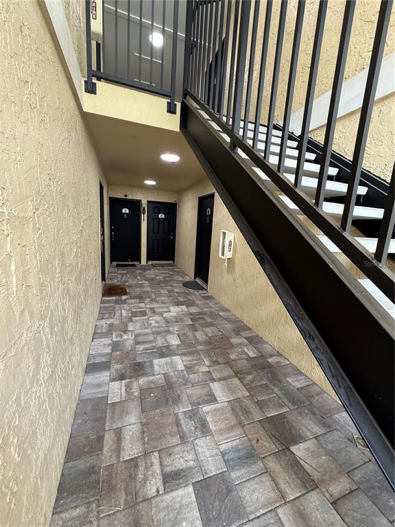 a view of entryway with a floor to ceiling window and stairs