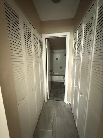 a view of a hallway with a wooden door