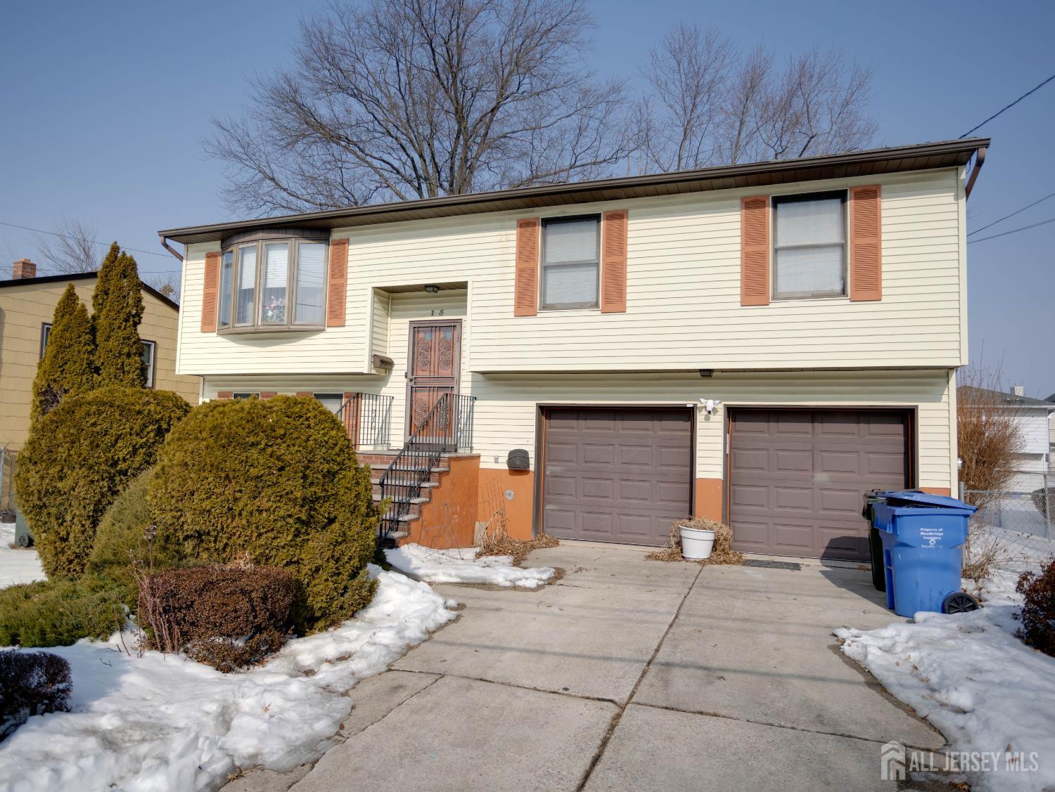 15 East Walnut Street Colonia, NJ 07067 - Photo 1 of 23 a front view of a house with garage