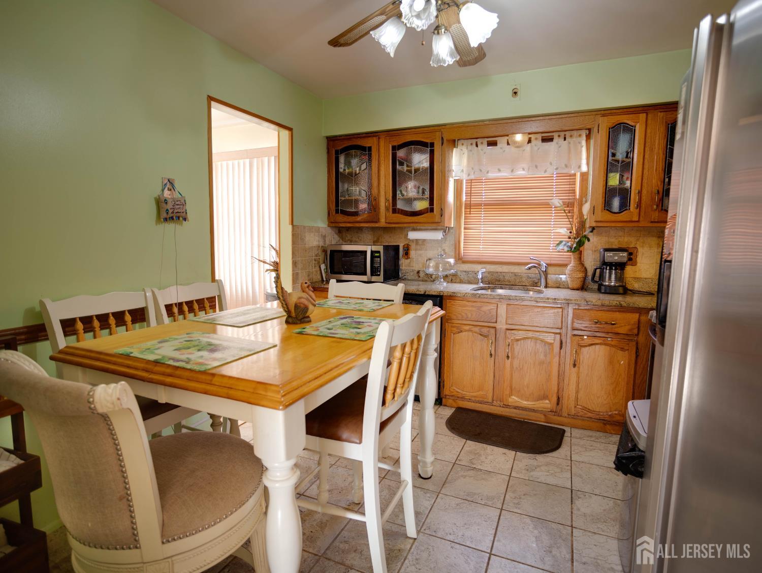 15 East Walnut Street Colonia, NJ 07067 - Photo 11 of 23 a dining table with chairs and window