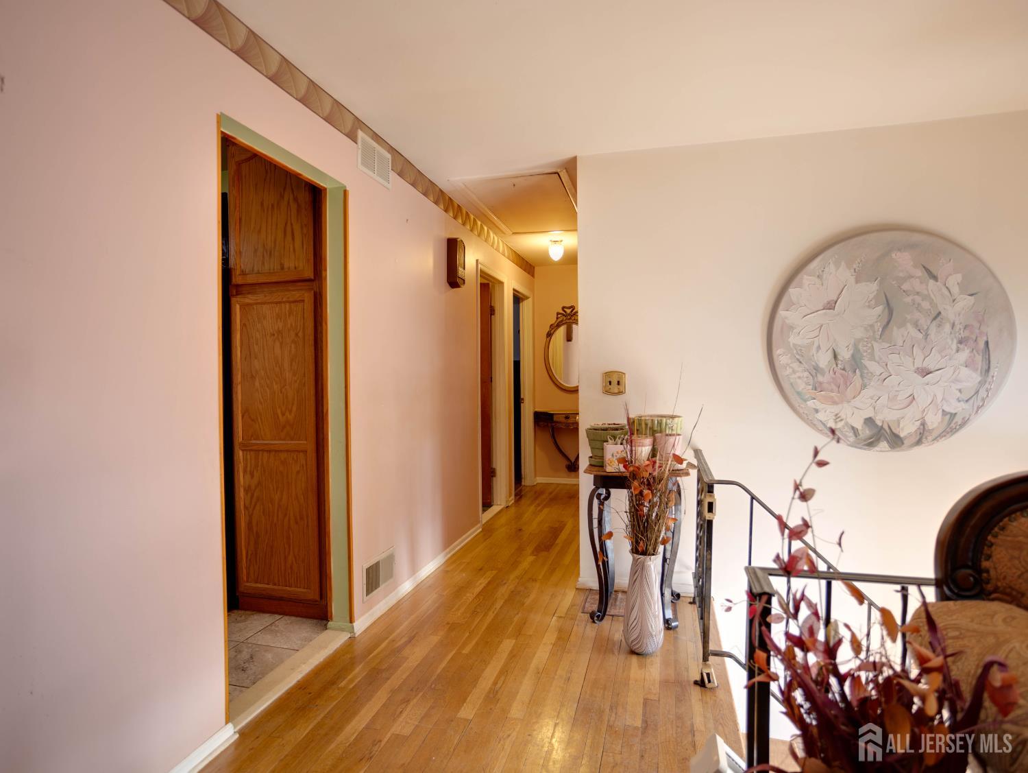 15 East Walnut Street Colonia, NJ 07067 - Photo 12 of 23 a view of a hallway with wooden floor and entryway