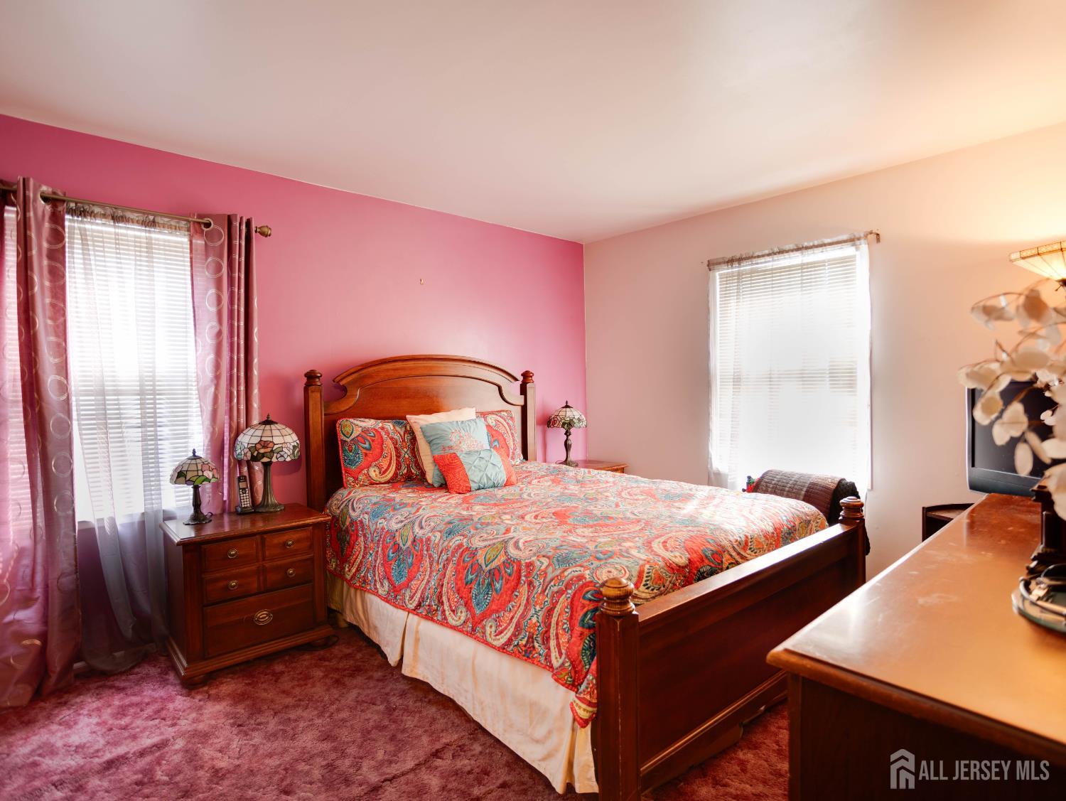 15 East Walnut Street Colonia, NJ 07067 - Photo 14 of 23 a bedroom with a bed and a dresser next to a window