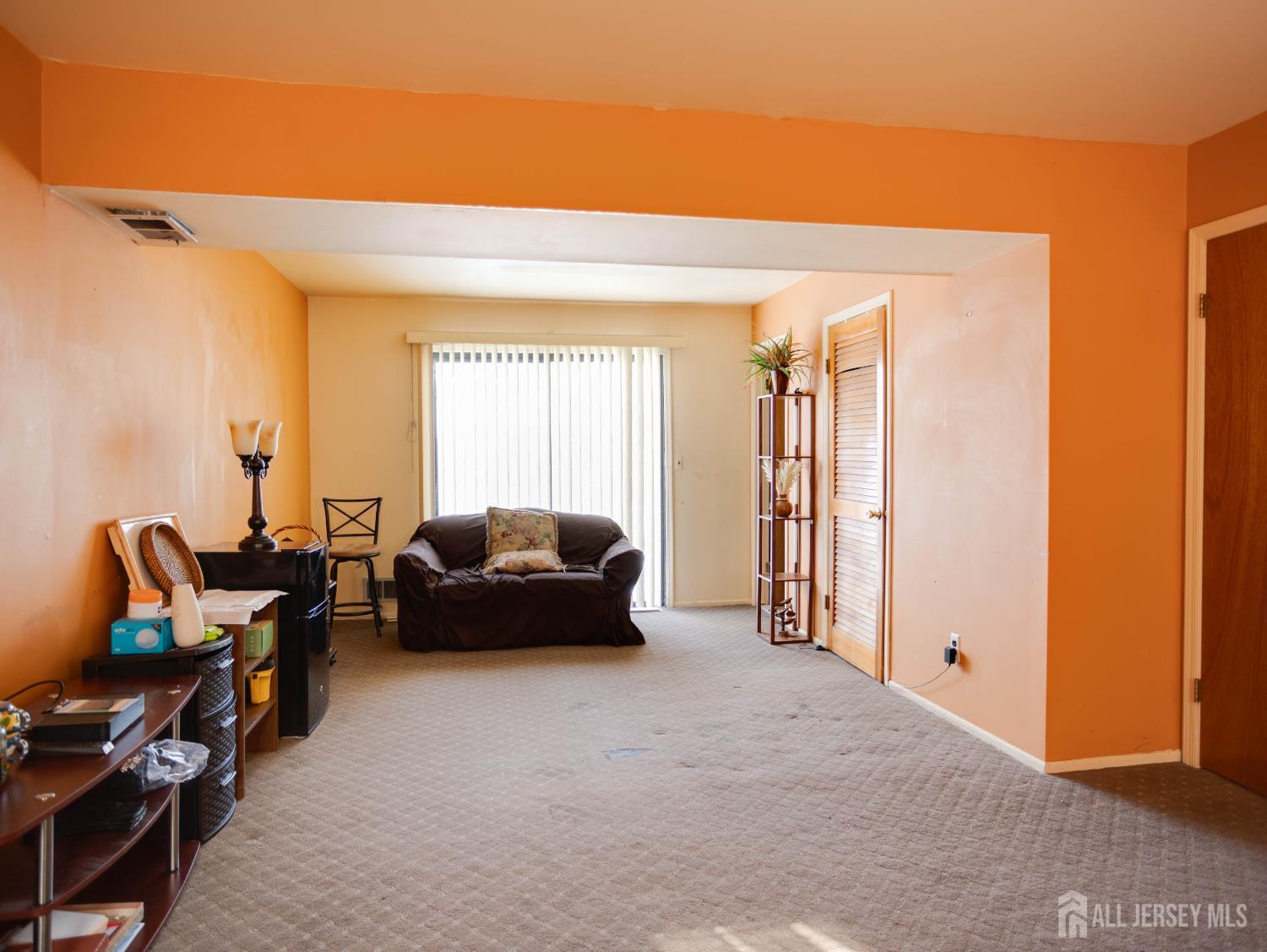 15 East Walnut Street Colonia, NJ 07067 - Photo 20 of 23 a living room with furniture a rug and a chandelier