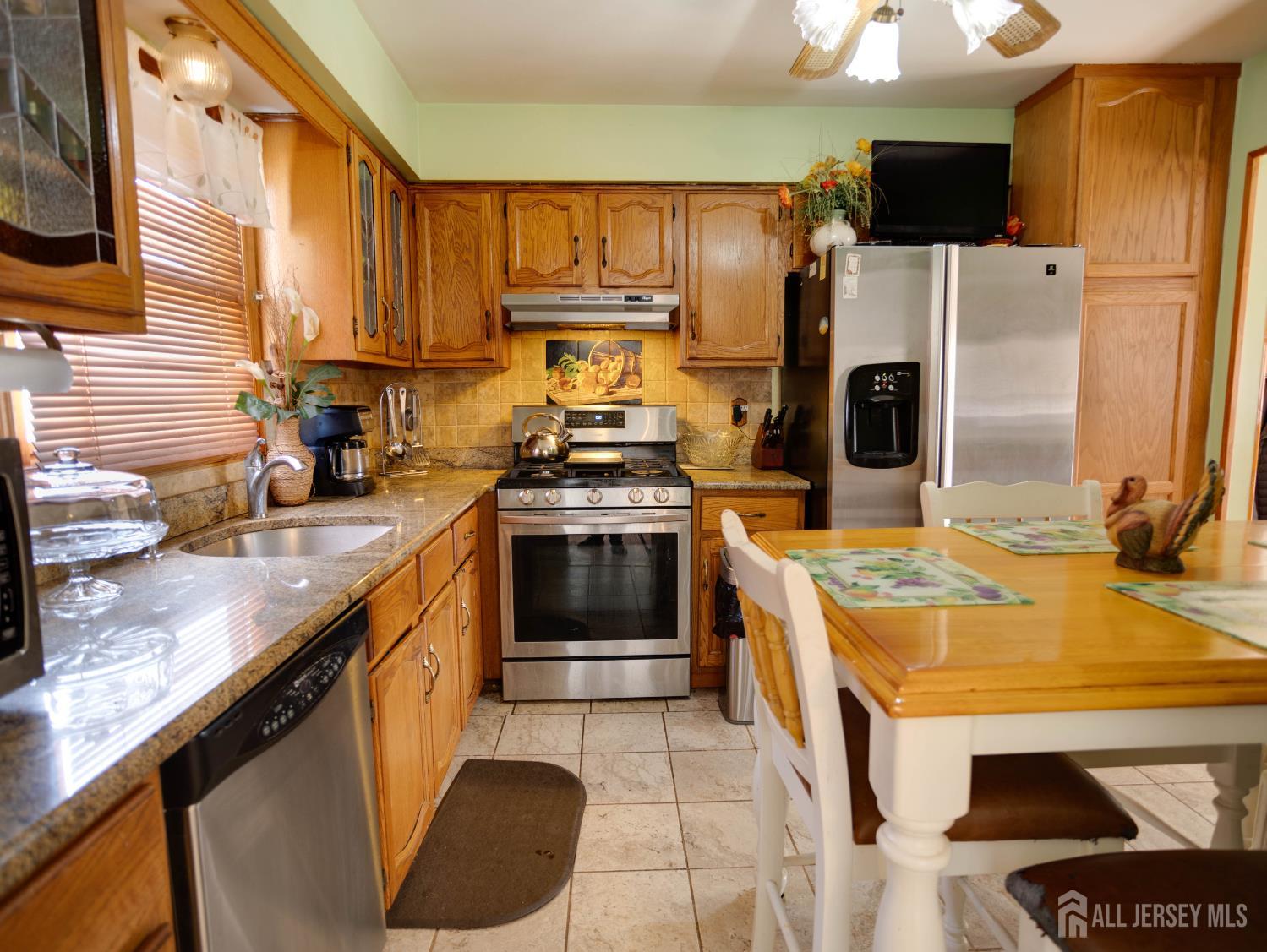 15 East Walnut Street Colonia, NJ 07067 - Photo 9 of 23 a kitchen with a sink stove and refrigerator