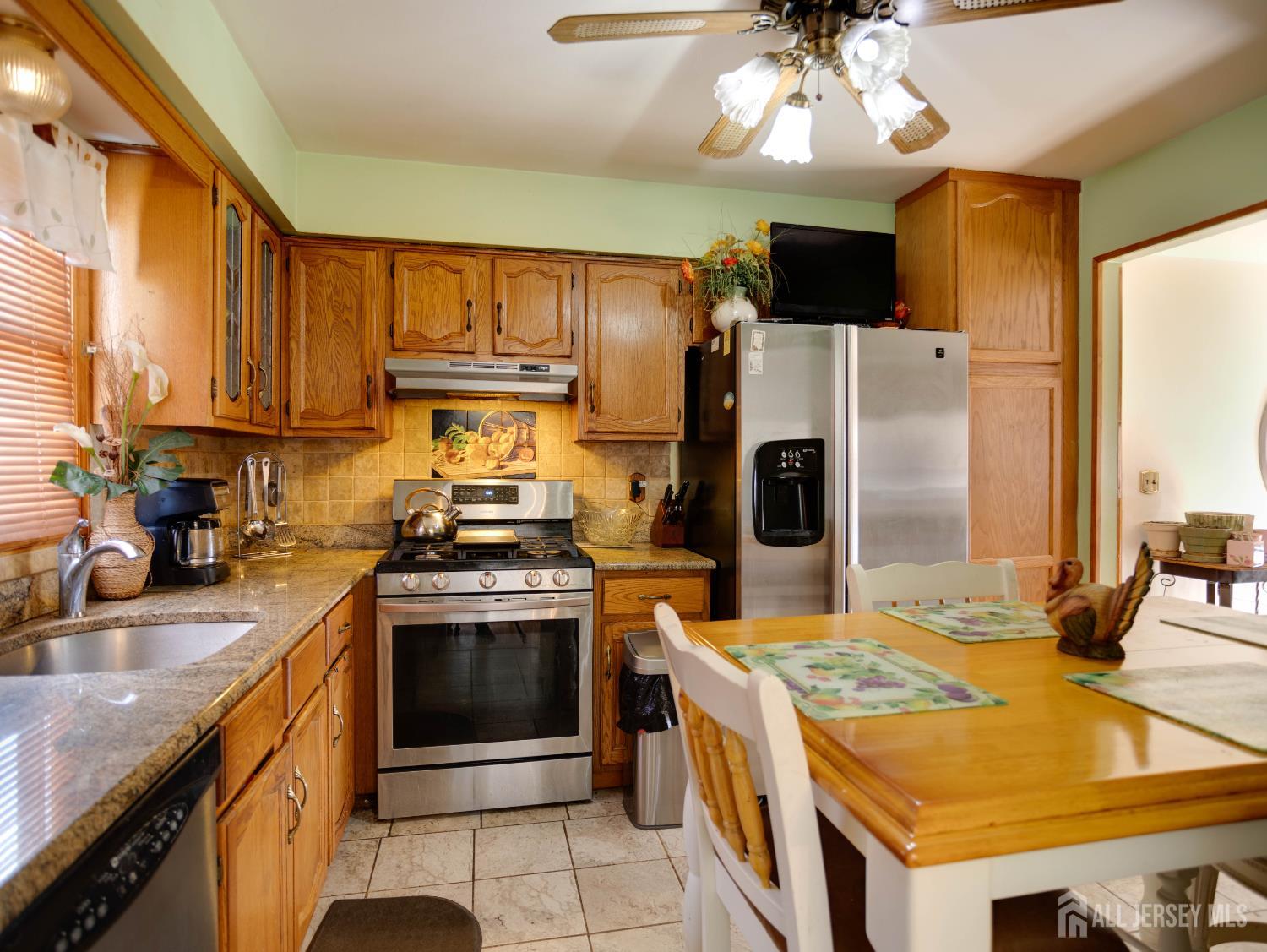 15 East Walnut Street Colonia, NJ 07067 - Photo 10 of 23 a kitchen with a stove and a kitchen