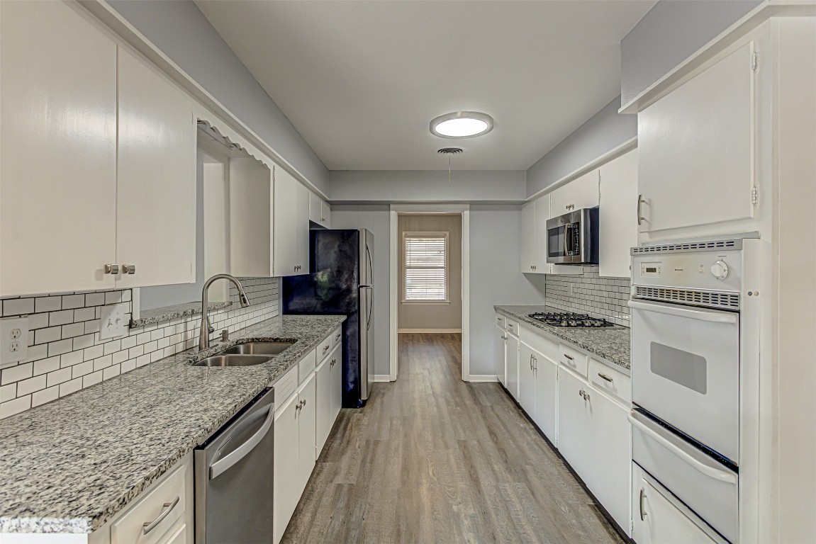 2001 Oakglen Drive Austin, TX 78745 - Photo 12 of 40 a large kitchen with stainless steel appliances granite countertop a stove sink and cabinets