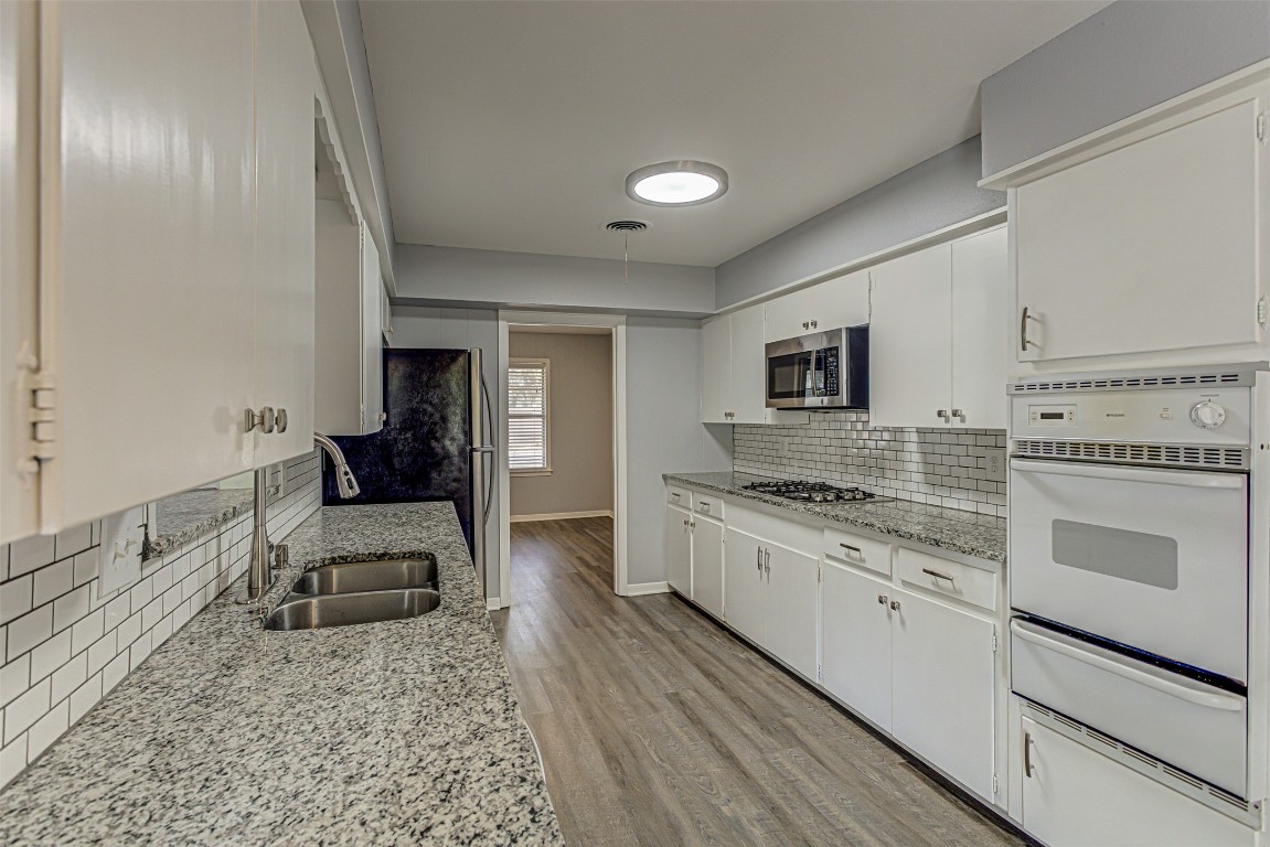 2001 Oakglen Drive Austin, TX 78745 - Photo 13 of 40 a kitchen with stainless steel appliances granite countertop a stove a sink and a refrigerator