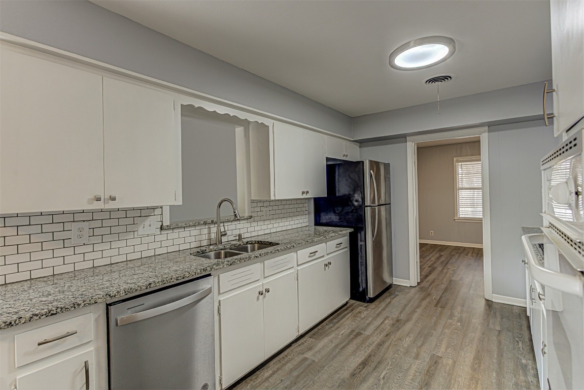 2001 Oakglen Drive Austin, TX 78745 - Photo 14 of 40 a kitchen with stainless steel appliances granite countertop a sink and cabinets