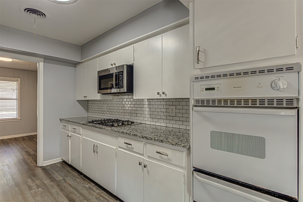 2001 Oakglen Drive Austin, TX 78745 - Photo 18 of 40 a kitchen with granite countertop white cabinets and white appliances