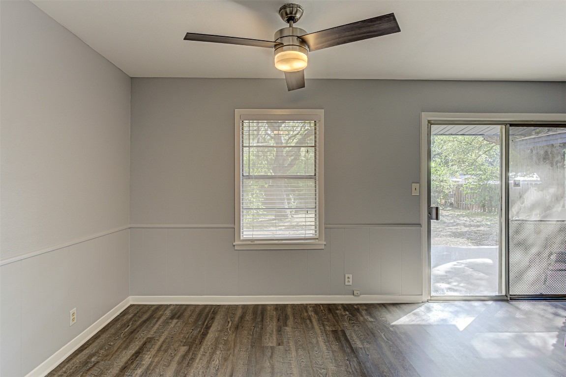 2001 Oakglen Drive Austin, TX 78745 - Photo 19 of 40 an empty room with wooden floor fan and windows