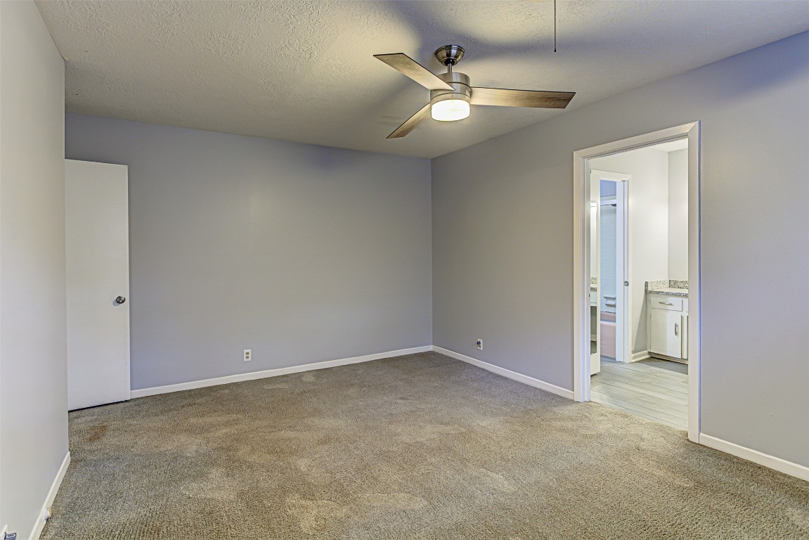 2001 Oakglen Drive Austin, TX 78745 - Photo 28 of 40 an empty room with a chandelier fan and closet