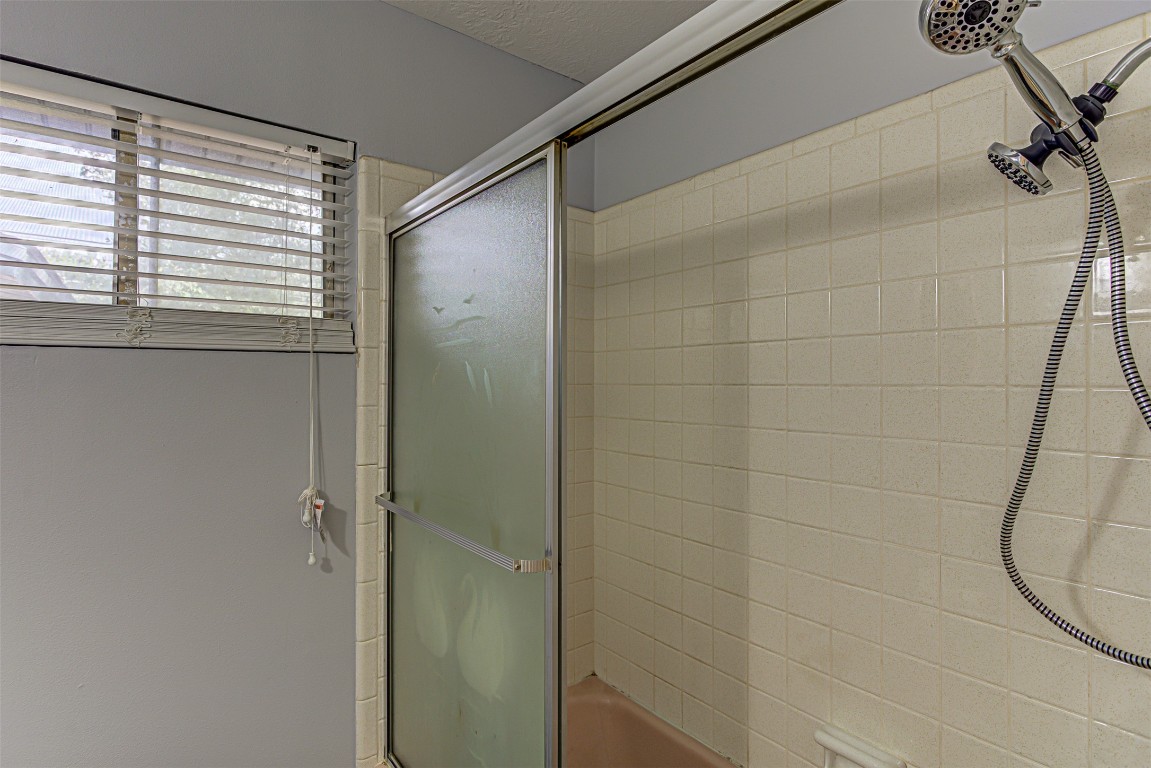 2001 Oakglen Drive Austin, TX 78745 - Photo 31 of 40 a bathroom with a shower and a window