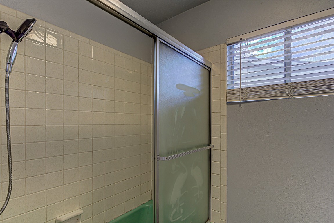 2001 Oakglen Drive Austin, TX 78745 - Photo 35 of 40 a bathroom with a shower and a window