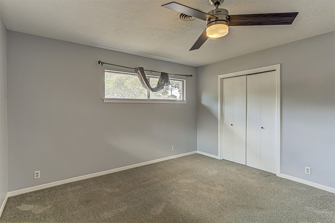 2001 Oakglen Drive Austin, TX 78745 - Photo 37 of 40 a view of a room with a ceiling fan and window