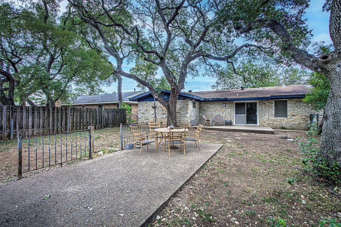2001 Oakglen Drive Austin, TX 78745 - Photo 40 of 40 a view of a white house with a large tree and wooden fence