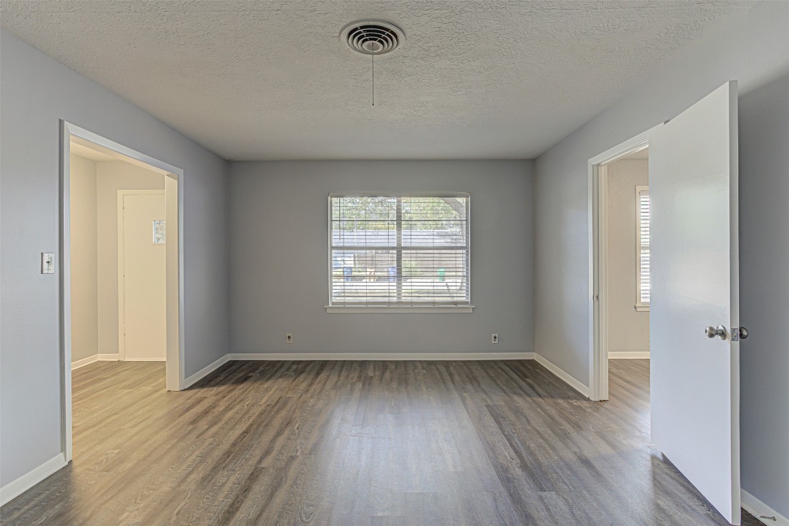 2001 Oakglen Drive Austin, TX 78745 - Photo 4 of 40 an empty room with wooden floor and windows